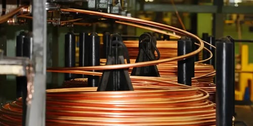 Pile of copper coils in industrial setting